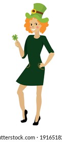 Red-haired girl joyous in a green dress celebrates St. Patrick's Day. the girl holds a clover in her hand