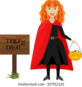 Red-haired girl vampire with candy and sign for advertising