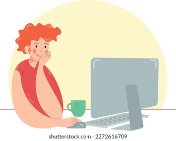 Redhead boy works at the computer. Freelancer or office worker sitting with computer and cup of coffee. Man is thinking and smiling with pleasure of work