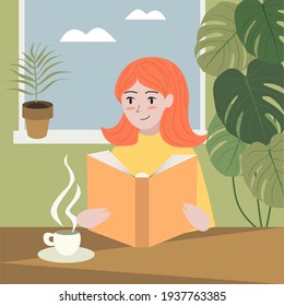 Redhead girl is reading a book while drinking coffee in cozy room with plants