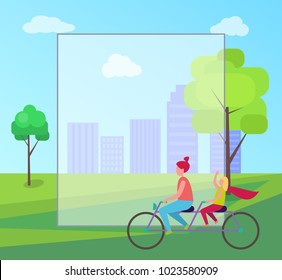 Redhead mother and her young blonde daughter riding purple tandem bicycle on background of skyscrapers in city park with frame for text.