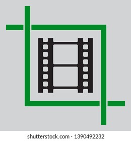 Reel of film sign. Black icon inside green crop tool at light gray background