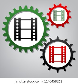 Reel of film sign. Vector. Three connected gears with icons at grayish background.