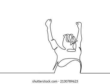 Rejoicing man sitting in a chair with his back turned raising his hands in the air.