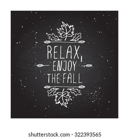 Relax, Enjoy the Fall. Hand-sketched typographic element with maple and oak leaves on chalkboard background. 