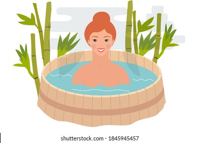 Relaxation in a barrel of water. Spa therapy for health and beauty. The girl smiles and sits in a wooden barrel with hot water. Wellness procedures in the sauna.