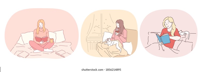 Relaxation with book at home, lazy bedding time concept. Young positive women in comfortable home clothing staying in bed, reading books and relaxing with cat and hot drink at home 