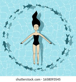 Relaxed girl swimming on the ocean surface. Clear water. Cute fish surrounded girl. Summer. Vacation. Top view
