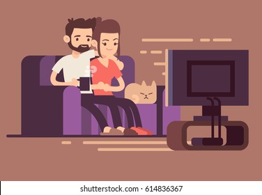 Relaxed happy young couple watching tv at home in living room