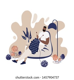 Relaxed knitting african man in a cosy beanbag chair. A man plying a needle in a modern flat style. Illustartion for themed clubs, magazine articles. Vector flat illustration