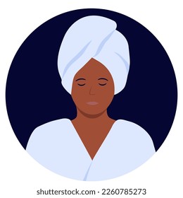 a relaxed woman in a bathrobe and with a towel on her head after taking a shower