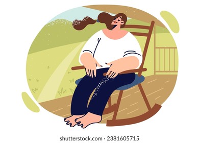 Relaxed woman sits on rocking chair in park or garden enjoying rays of summer sun. Relaxed, carefree girl is relaxing in backyard of own house with green lawn, after difficult work week.