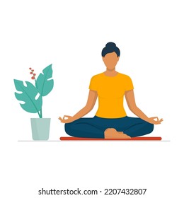 Relaxed woman sitting in the lotus position and practicing meditation