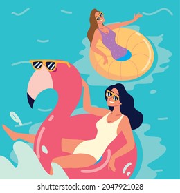 relaxed women in inflatable rings in the pool