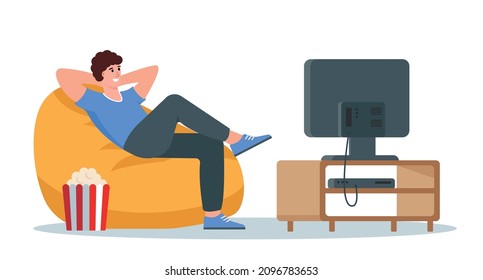 Relaxed young man sitting on armchair and watching TV. Male character resting on bean bag after work with popcorn and television. Flat or cartoon vector illustration. svg