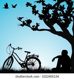 Relaxing bicyclist  under a tree