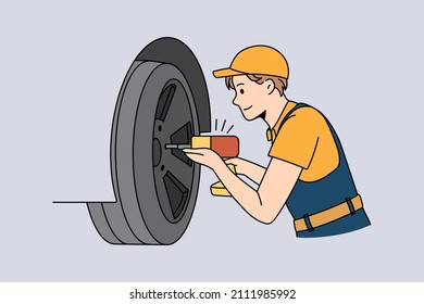 Repairing and working with cars concept. Young man worker repairman mechanic in uniform and cap fixing and working with cars wheel with drill vector illustration 