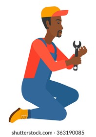 Repairman holding spanner.