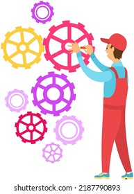 Repairman in red overall working, locksmith engineer fixes breakdown in group of gears. Man holding screwdriver. Repair and maintenance service concept. Male character repairing broken mechanism