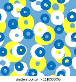 Repeated colored circles. Geometric seamless pattern with round shapes drawn by hand. Endless print for children. Vector illustration. Blue, yellow, white.