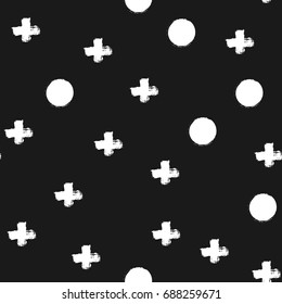 Repeated crosses and circles drawn with a brush. Seamless pattern. Grunge, graffiti, ink, sketch, watercolor. White shapes on a black background. Vector illustration.
