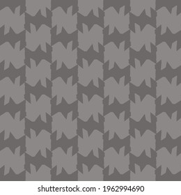 Repeated decorative design, like a mosaic, composed of patches and shapes with angular and sharp contours. Fashion pattern in gray shades.