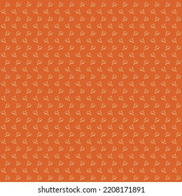 Repeated decorative design made up of small signs or marks arranged on a vertically wavy and horizontally linear path. Textile pattern. Orange wrapping paper.