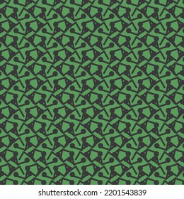 Repeated decorative design, a mosaic composed of broken lines and some round, triangular and polygonal shapes. Textile pattern made in black on a green background.