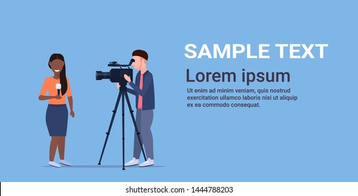 reporter man with african american woman journalist presenting live news operator using video camera on tripod recording correspondent with microphone movie making concept horizontal copy space