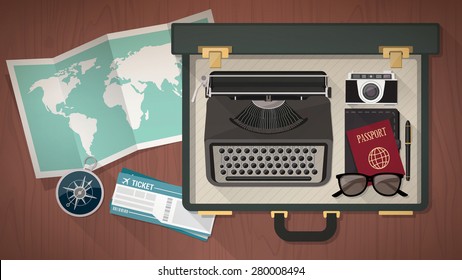 Reporter and writer vintage open suitcase with a typewriter, camera, passport world map, plane tickets and compass, top view