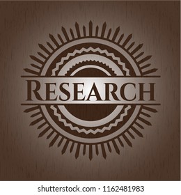 Research badge with wooden background