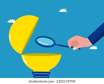 Research. Businessman using a magnifying glass to look at a light bulb