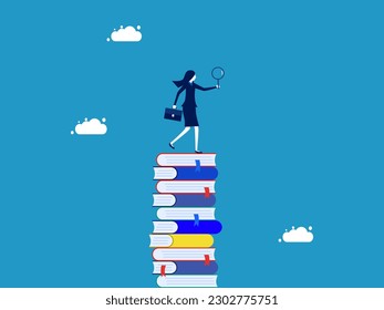 Research and find information. Businesswoman using a magnifying glass to search for a large amount of information in a tall stack of books