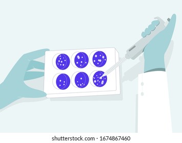 The Researcher examines some samples of the new coronavirus in the laboratory. The close-up hands are holding the micropipette and some samples to find virus.