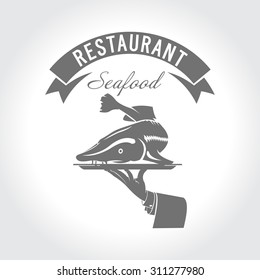 Restaurant, cafe. Seafood, fish menu. Sturgeon on a platter in his hand for the waiter.