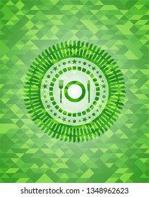 restaurant icon inside green emblem with mosaic background