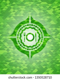 restaurant icon inside green emblem with triangle mosaic background