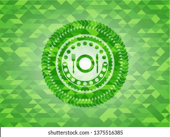 restaurant icon inside green emblem with mosaic background