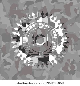 restaurant icon inside grey camouflaged emblem