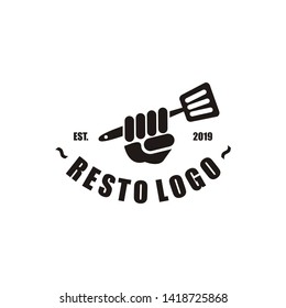 The restaurant logo with the hand icon holding the spatula