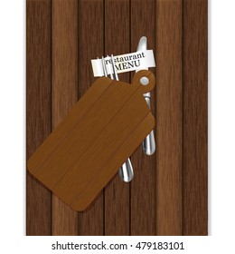 Restaurant menu with cutting board on a wooden background, knife and fork with ribbon and inscription restaurant menu. Isolated object, you can use any background image or text.