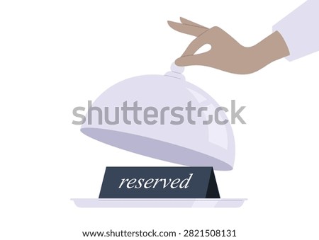 Restaurant table booking system, a waiters hand lifting a cloche, revealing a reserved sign on a tray