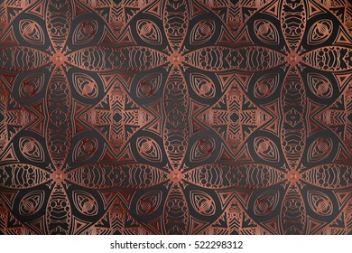 retro abstract symmetrical pattern embossed art deco on a brown background
