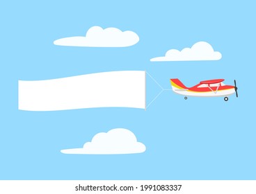 Retro aircraft with ribbon banner advertising, in the sky above the clouds.