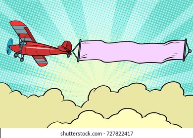 Retro airplane with a ribbon in the sky. Pop art retro vector illustration
