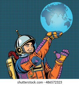 Retro astronaut is holding the planet Earth on hand pop art retro vector. Caring for the planet. Earth day and the day of environmental protection