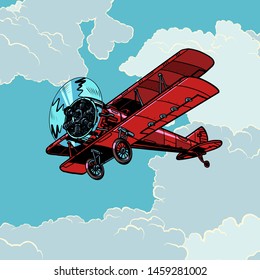 retro biplane plane flying in the clouds. Pop art vector illustration vintage kitsch