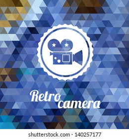 Retro camera on color background made of triangles. Vector background with geometric shapes.
