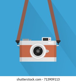 Retro camera or vintage camera in a flat style on a colored background.