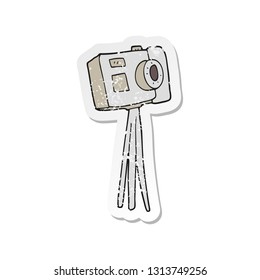retro distressed sticker of a cartoon camera on tripod